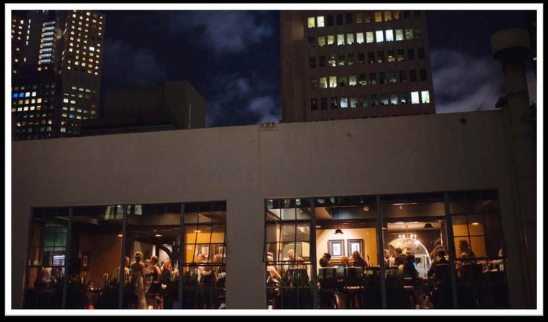 Amador Club — exterior at night with SF skyline